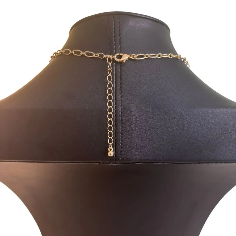 Gold Tone Multi-Charm Necklace w/ Puffy Heart, White Clocer & Gold Bow.